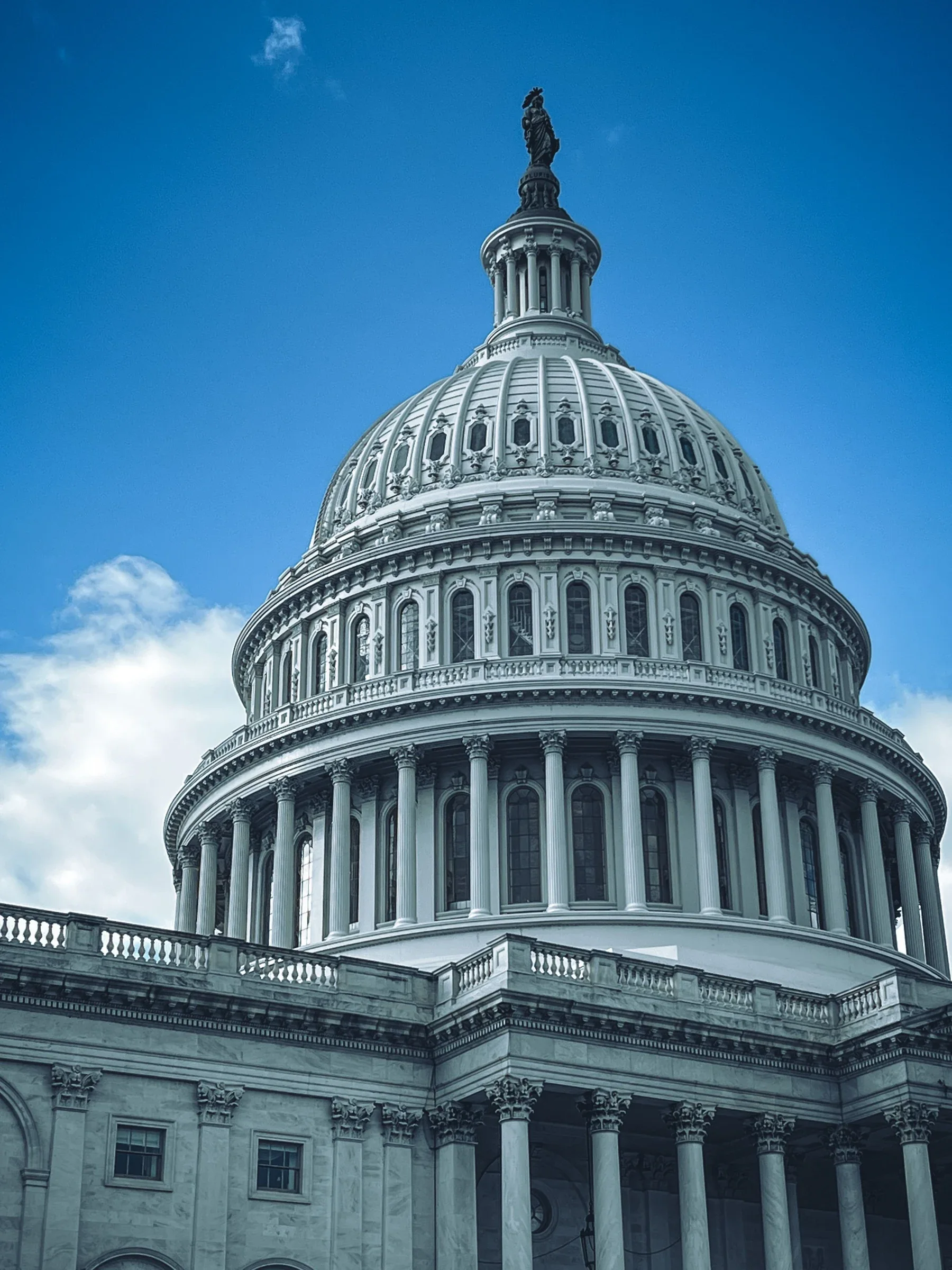 The United States Capitol dome against a blue sky, representing federal digital-asset legislation.