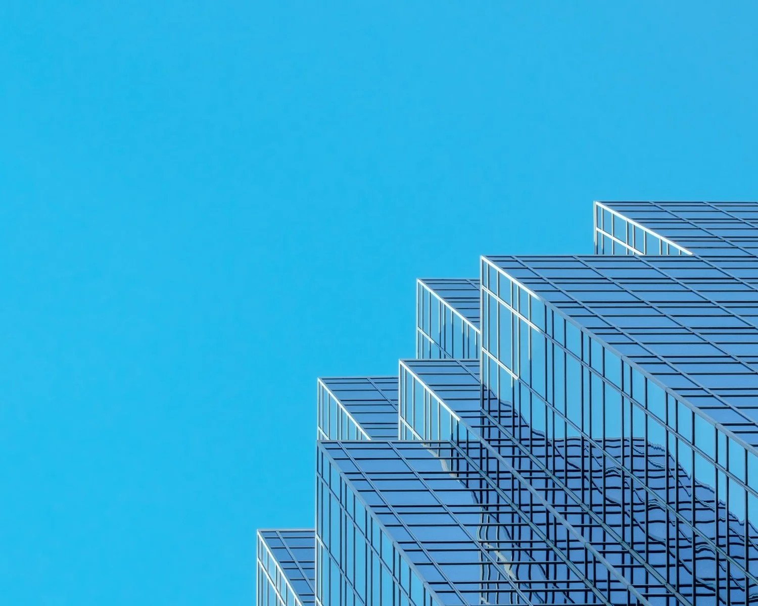 Glass skyscraper in Boston's financial district; illustrative finance photograph, not Evernorth's office.
